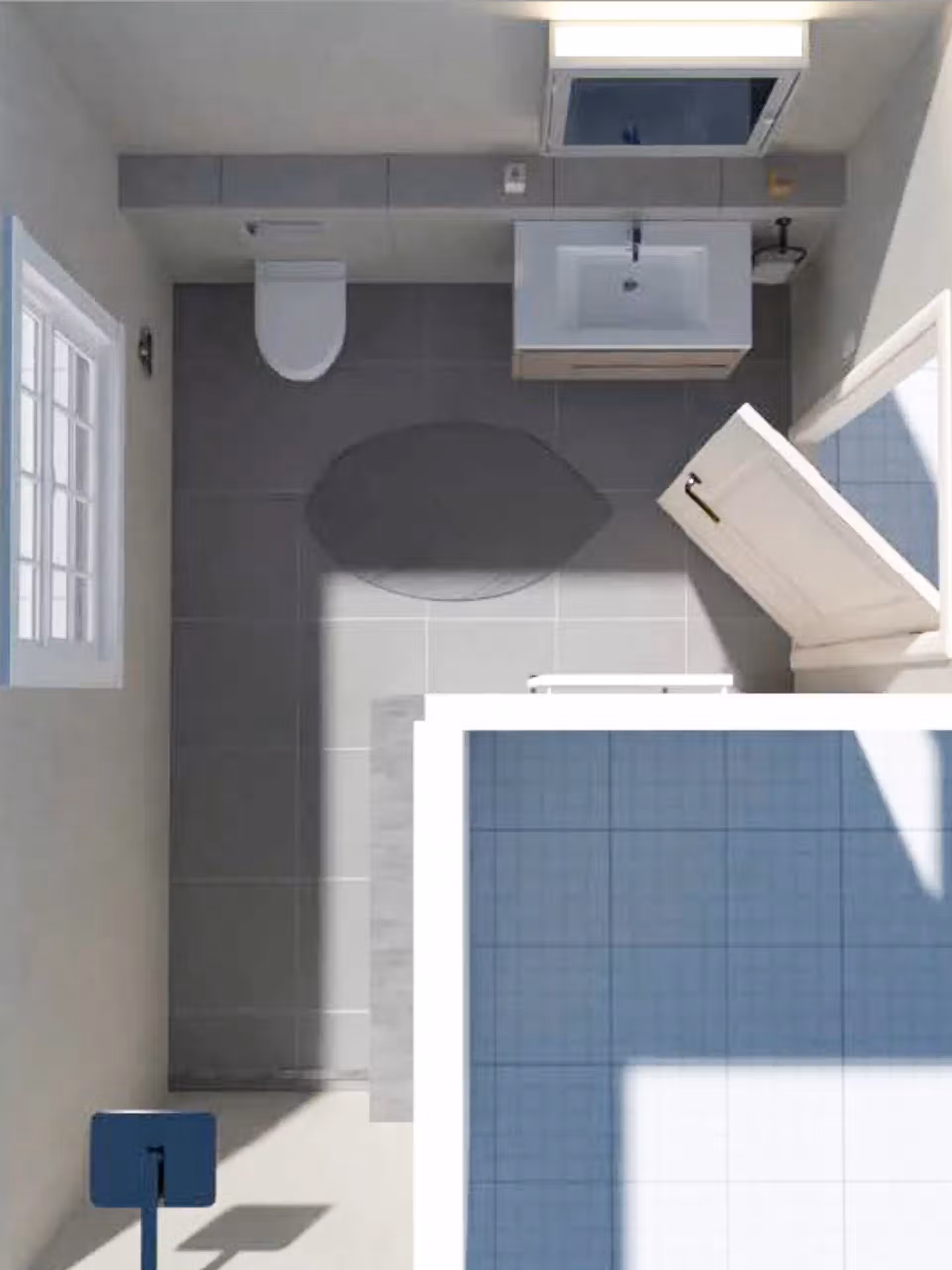 Vue aérienne d'une salle de bain moderne avec baignoire, lavabo et toilettes, carrelage gris et éléments en bois.